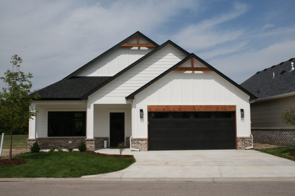 An exterior photo of 2016 W 12th. It's a white patio home featuring black and cedar trim.